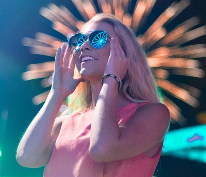 A woman wearing sunglasses at night