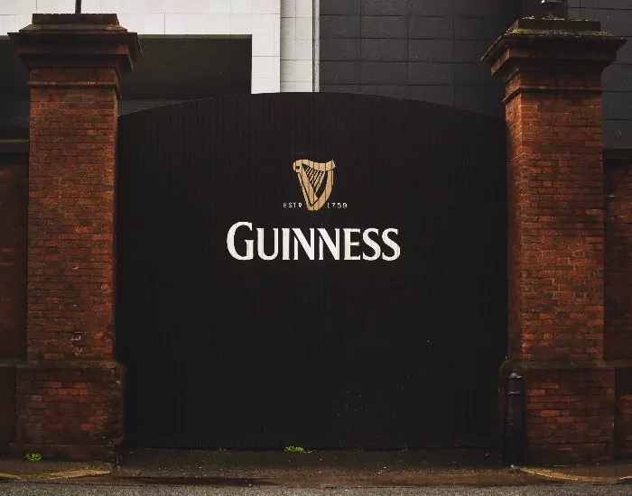 A black gate with the Guinness beer logo on it