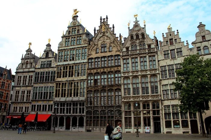 tall ornate buildings line a square in Antwerp