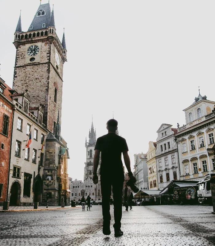 A man walking on a street in Prague
