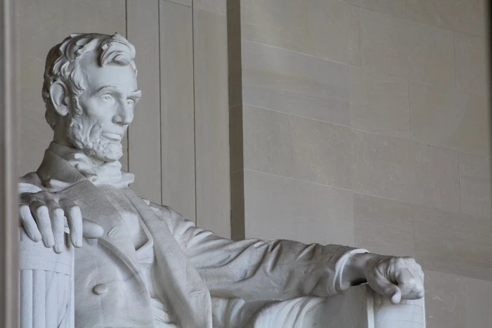 The statue of Lincoln sitting in a chair in the Lincoln Memorial