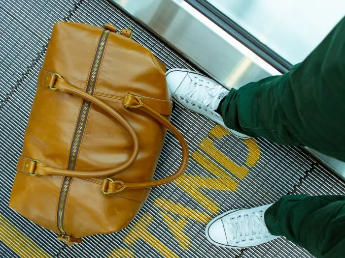 A brown bag sits on a moving walkway