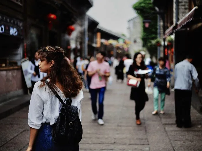 A woman walking down a busy street 