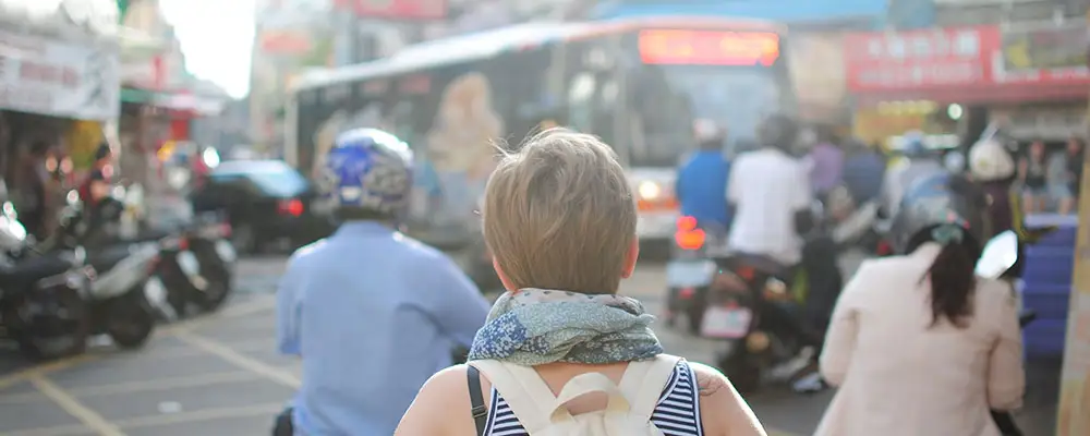 The back of a woman walking down a busy street