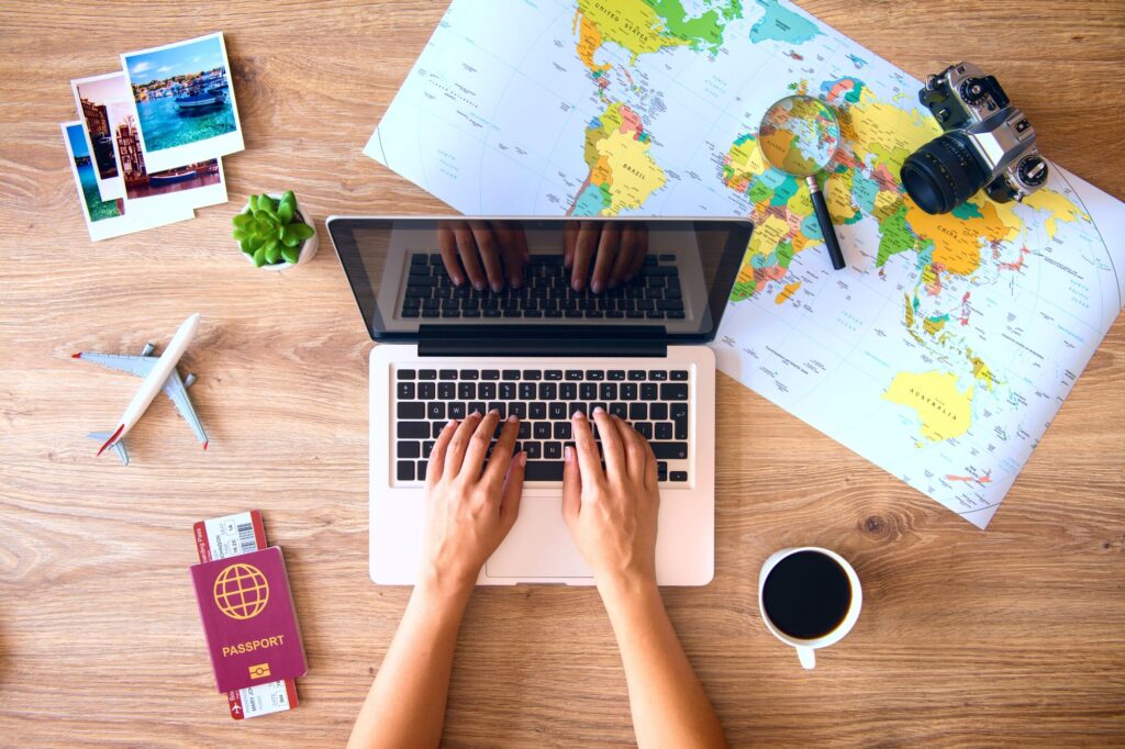Young women traveler planning vacation trip at her laptop EU electronic visa 2024