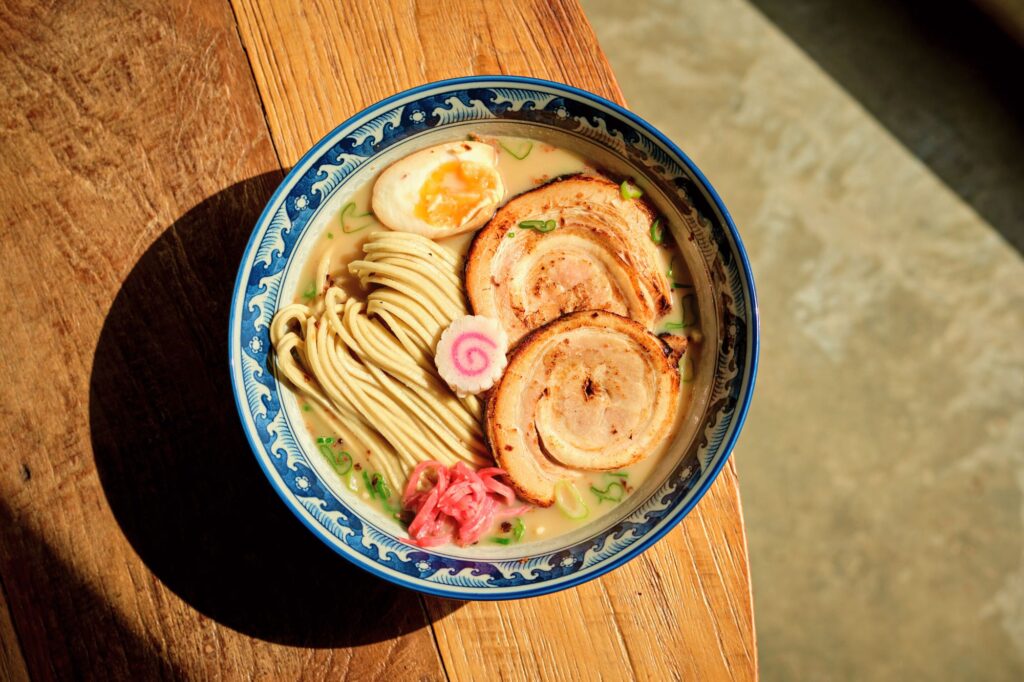 Savory bowl of ramen as seen in 'Naruto,' a culinary staple for anime-loving travelers in Japan.
