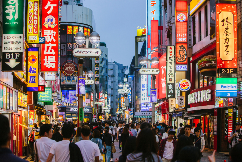 Neon-lit Tokyo offering work and cultural exchange opportunities for travelers.