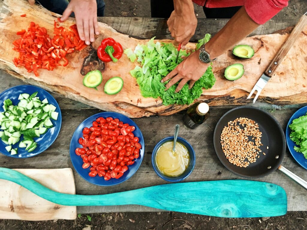 Fresh, colorful ingredients laid out on a wooden surface for a healthy cooking class in the South Pacific, an affordable bonding activity for students and mothers.