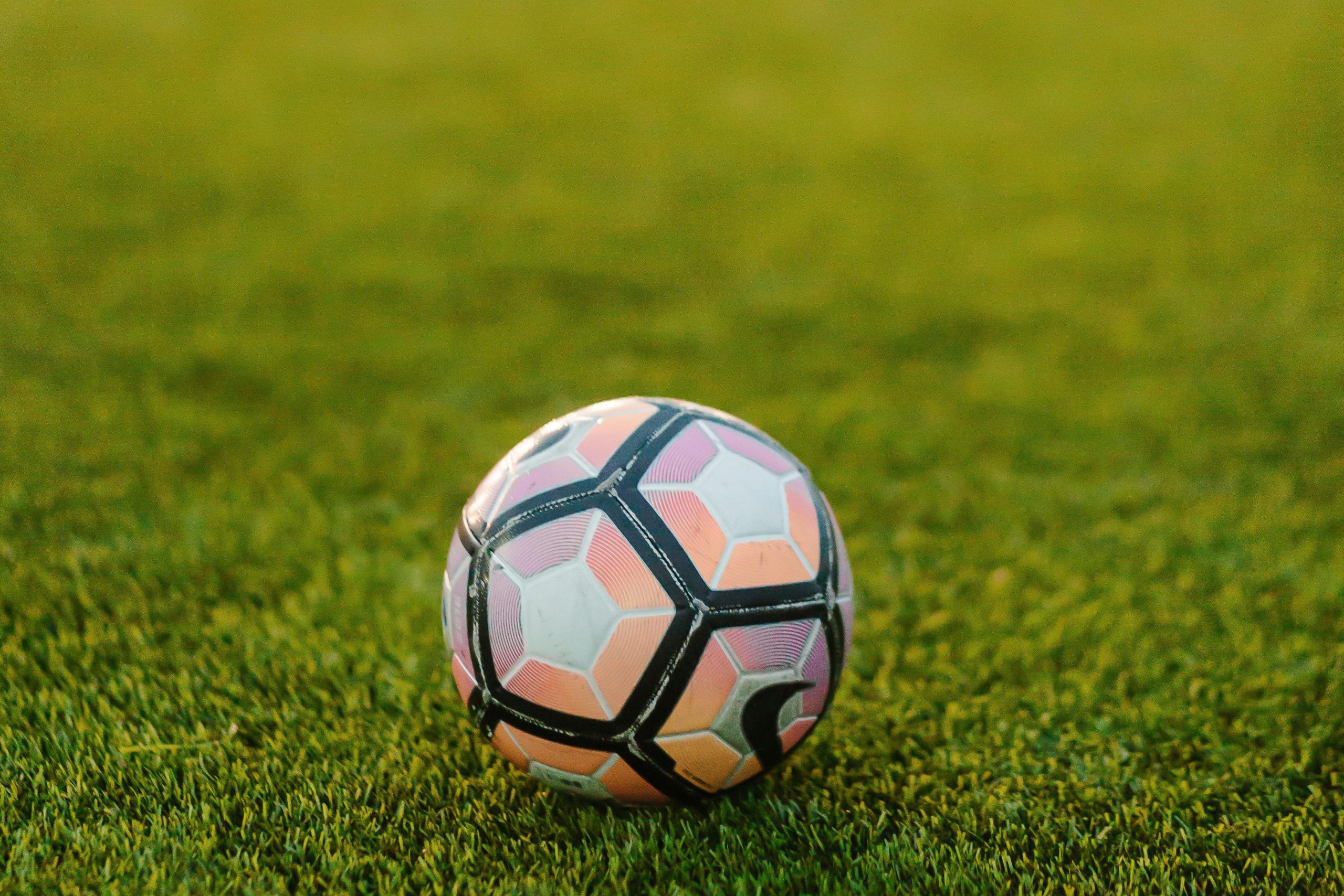 Soccer ball resting on a grass field before a FIFA World Cup match